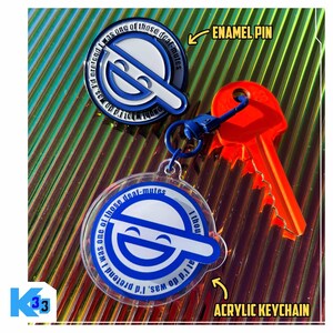 May include: An enamel pin and acrylic keychain featuring a blue and white design with the text "I was one of those deal-mutes." The keychain is attached to a blue key ring and a bright orange key.