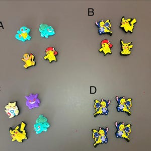 May include: A collection of colorful rubber shoe charms featuring various cartoon characters, organized into four labeled groups A, B, C, and D. The charms depict yellow, blue, green, and purple figures, including Pikachu, Squirtle, and Bulbasaur.