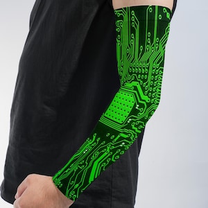 May include: An arm sleeve featuring a vibrant neon green circuit board pattern printed on a black background. The design displays intricate lines, nodes, and a central grid of dots, mimicking the appearance of electronic hardware components.