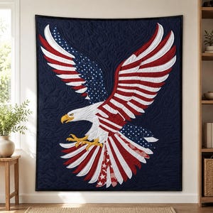 May include: A navy blue quilt featuring a large American bald eagle design. The eagle's wings are spread, displaying red and white stripes and white stars on a blue background. The eagle has a white head, yellow beak and talons.