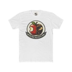 May include: White t-shirt with a graphic of a bitten apple, half red and half rotten brown with a worm. The design is encircled with the text "Rotten Fruit Falls on Its Own". A casual tee.