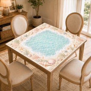 May include: A square wooden dining table featuring a tabletop surface printed with a light blue ocean water design surrounded by a border of various seashells, starfish, and coral reefs, accompanied by four matching upholstered wooden chairs.