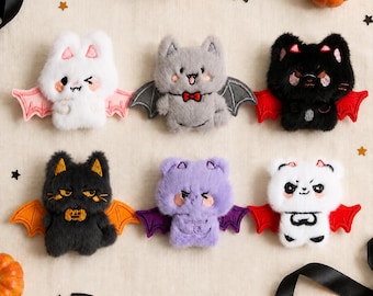 May include: Six plush bat-cat hybrid toys arranged in two rows. The top row features a white bat with pink wings, a grey bat with a red bowtie, and a black bat with red wings. The bottom row includes a black bat with orange wings, a purple bat, and a white bat with black markings and red wings.