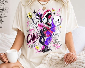 Comfort Colorsの素晴らしいデジタルサーカスシャツ、ケインキャラクターTシャツ、TADCネオンコミックシャツ、女性向けファングッズギフト