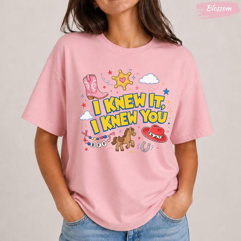 Oversized tee with “I Knew It, I Knew You” western graphic, pink boot, cowboy hat, horse, sheriff star, clouds, stars, and BFF beads.