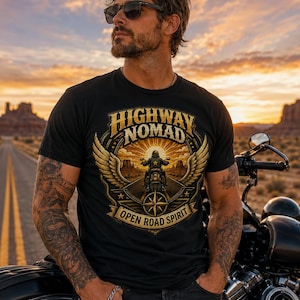 May include: Black t-shirt with a graphic featuring a motorcycle rider, wings, and the words "HIGHWAY NOMAD OPEN ROAD SPIRIT." The image is set against a desert landscape with a motorcycle.