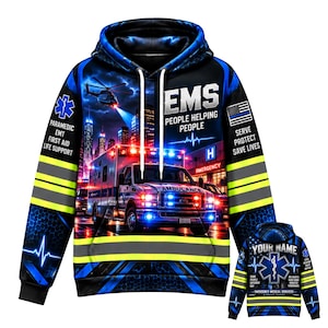 May include: A black hoodie featuring a graphic print of an ambulance, a helicopter, and a city skyline. The text reads EMS PEOPLE HELPING PEOPLE, PARAMEDIC EMT FIRST AID LIFE SUPPORT, and SERVE PROTECT SAVE LIVES. The sleeves have yellow reflective stripes.