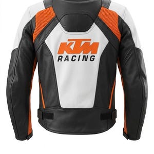 May include: Black, white, and orange motorcycle jacket with the KTM Racing logo on the back. The jacket features a combination of leather and other materials, with orange accents on the shoulders and sides. The back panel is white.
