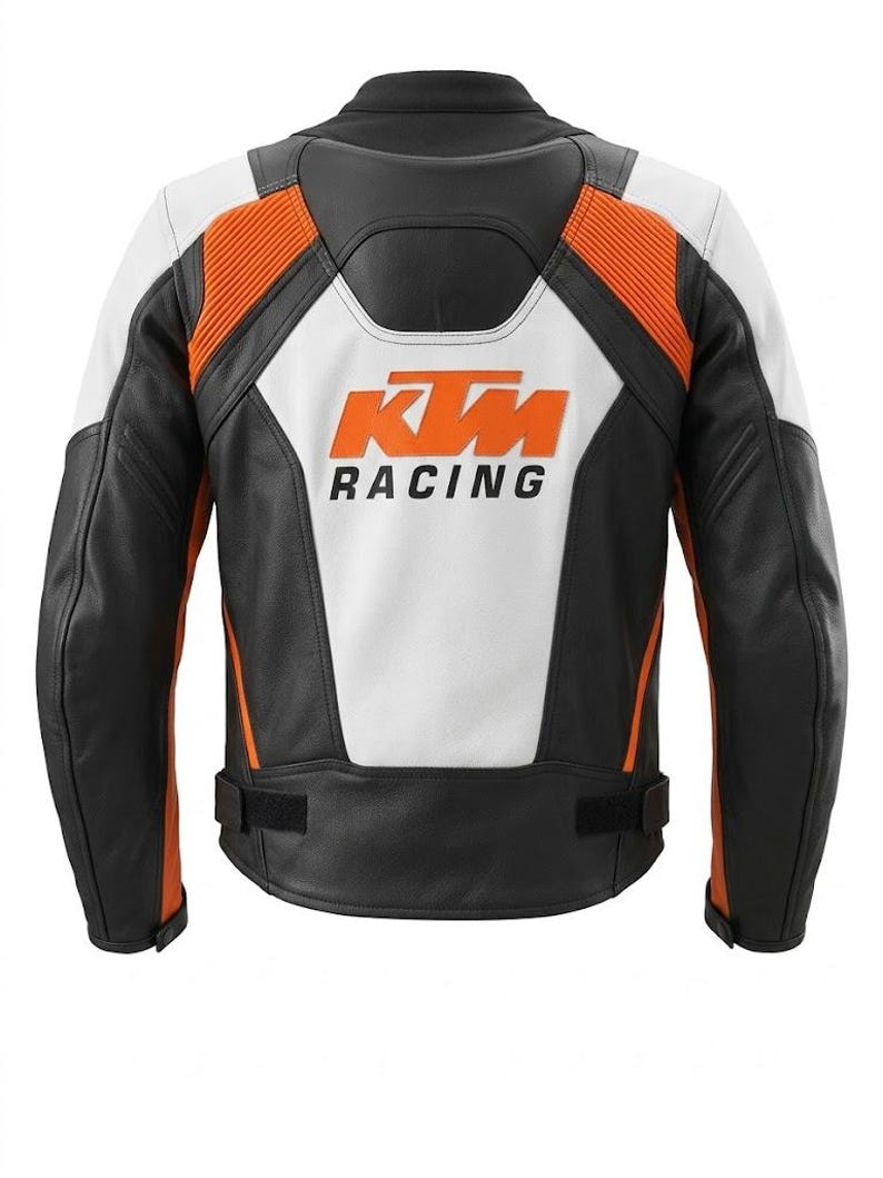 May include: Black, white, and orange motorcycle jacket with the KTM Racing logo on the back. The jacket features a combination of leather and other materials, with orange accents on the shoulders and sides. The back panel is white.