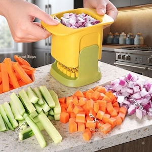 May include: A yellow and light green vegetable chopper with a square hopper containing chopped red onion. The device sits on a countertop next to piles of sliced cucumber, diced carrots, and diced red onion with labels Carrot Strips, Diced carrot, and Onion dice.