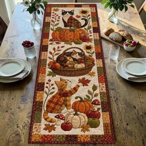 May include: A rectangular quilted table runner featuring an autumnal pattern with three sections. Each section displays cats, pumpkins, mushrooms, and autumn leaves in shades of orange, brown, red, and green, bordered by a patchwork fabric frame.