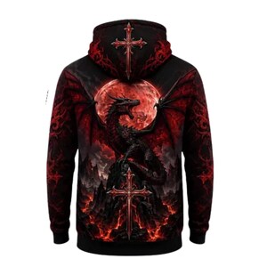 May include: A black long-sleeve hooded sweatshirt featuring a graphic print of a black dragon perched on a rocky peak against a large red moon. The design includes two ornate red crosses, one on the hood and one below the dragon, with red lava.