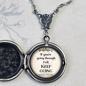 May include: Silver locket necklace with a quote from Winston Churchill: "If you're going through Hell, keep going".