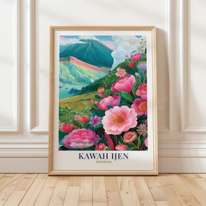 May include: A vertical rectangular art print in a light wood frame featuring a landscape of Kawah Ijen, Indonesia. The scene depicts a volcanic mountain with teal and pink slopes, white clouds, and a foreground filled with vibrant pink flowers.