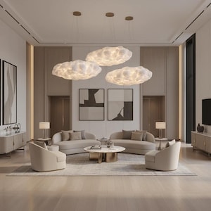 May include: A modern living room featuring cloud-shaped pendant lights, beige sofas, and armchairs. The room includes a round coffee table, artwork, and a neutral color palette, creating a sophisticated and inviting atmosphere.