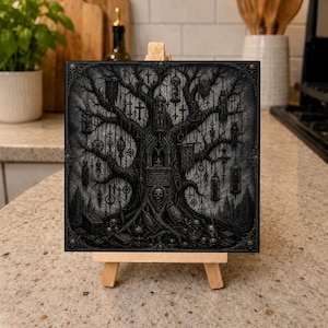May include: A square black and white art print on a wooden easel featuring a detailed illustration of a gnarled tree with hanging cages, crosses, and occult symbols, with a central archway, a skull at the base, and various scattered objects.
