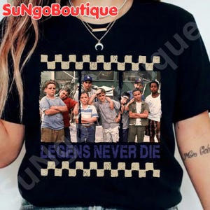 May include: Black t-shirt featuring a group of boys in a vintage photograph. The shirt has a checkered border and the text "LEGENDS NEVER DIE" in a distressed font. The shirt is a crew neck.