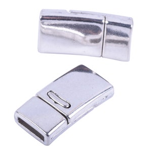 May include: Two silver magnetic clasps for jewelry making. The clasps are rectangular and have a smooth, polished finish.