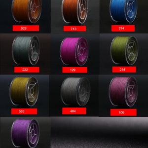 May include: Twelve spools of fishing line in various colors, including orange, blue, green, purple, gray, and yellow. Each spool is labeled with a number.