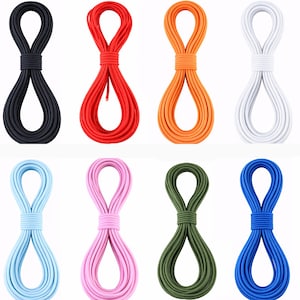 May include: A collection of twelve coiled cords in various solid colors including purple, black, red, orange, white, beige, light purple, light blue, pink, olive green, blue, and dark brown, each secured with a matching wrapped center band.