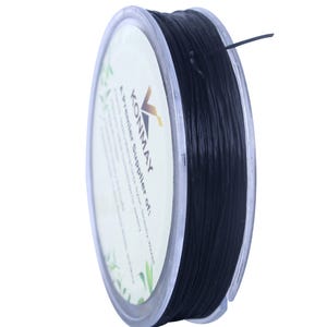 May include: A spool of black elastic cord, wound around a clear plastic bobbin. The label on the bobbin reads "KONMAY A premier supplier of..."