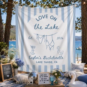 May include: A white and light blue striped fabric backdrop featuring the blue text LOVE ON the Lake, Est. 2026, a bikini illustration, a cocktail glass, a flamingo float, and the text taylor's Bachelorette LAKE TAHOE, CA printed in blue.