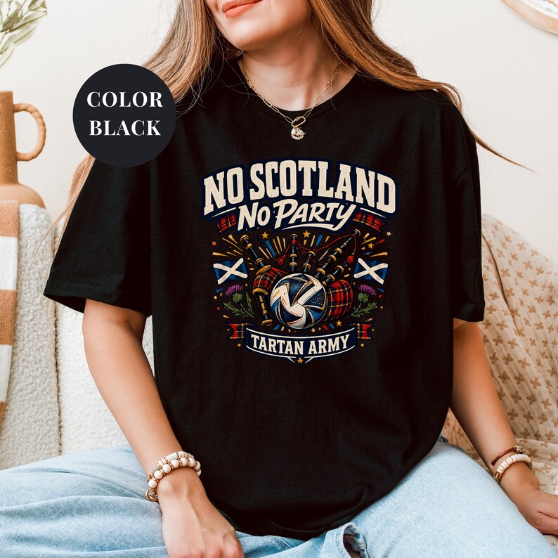 A woman wearing a black t-shirt with a graphic design that says "NO SCOTLAND NO PARTY TARTAN ARMY".