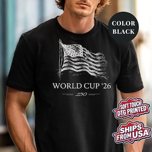 Black Comfort Colors 1717 t-shirt featuring a minimalist vintage sketch of a waving American flag. Includes "WORLD CUP '26" and a stylized "250" text celebrating the USA Semiquincentennial. Premium patriotic sports apparel for United States soccer fans and 2026 host nation supporters.