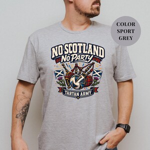 A man wearing a grey t-shirt with a graphic design that says "No Scotland No Party Tartan Army".