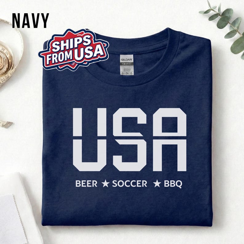 Navy USA T-shirt for Soccer Fans featuring bold block letters and ‘Beer Soccer BBQ’ slogan, patriotic graphic tee for World Cup 2026 and game day wear.
