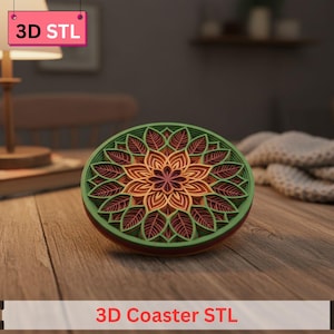May include: A layered, round coaster with a floral design. The coaster features a green outer ring, with layers of orange, red, and purple. The text "3D Coaster STL" is at the bottom of the image.