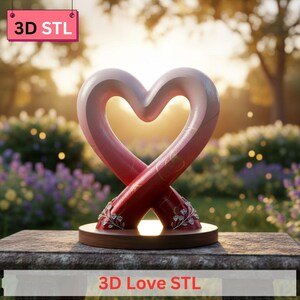 May include: A 3D-printed heart sculpture with a gradient of pink and red hues, resting on a wooden base. The sculpture features decorative floral accents and the text "3D Love STL". The background shows a blurred garden scene.