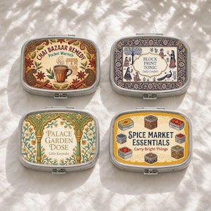 May include: Four rectangular metal tins with rounded corners and hinged lids. Each lid features a unique colorful illustration and text: Chai Bazaar Remedy, Block Print Tonic, Palace Garden Dose, and Spice Market Essentials with small box icons.