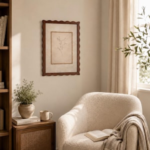 May include: A rectangular wall art piece featuring a dark brown scalloped wooden frame. The artwork displays a delicate, thin-lined botanical illustration of a sprig with small leaves centered on a textured, light beige background.