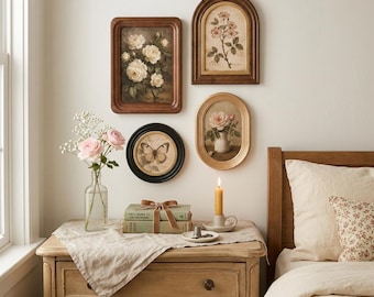May include: A collection of four framed wall art pieces featuring floral and butterfly illustrations, a clear glass vase with pink roses, two stacked books tied with a brown ribbon, and a yellow candle in a ceramic holder on a wooden dresser.