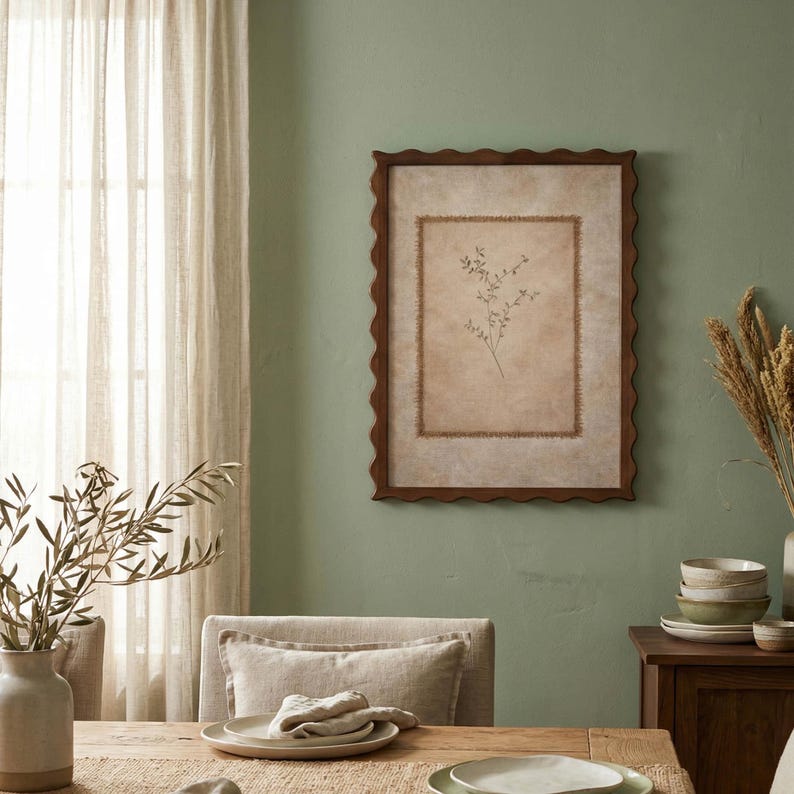 May include: A rectangular wall art piece featuring a dark brown scalloped frame. The artwork displays a central beige panel with a frayed edge border, containing a delicate, thin-lined botanical illustration of a small sprig with leaves.