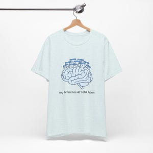 May include: A set of three ceramic mugs with a speckled, matte finish. The mugs are in shades of cream, light gray, and dark gray. Each mug has a simple, minimalist design, perfect for coffee or tea.