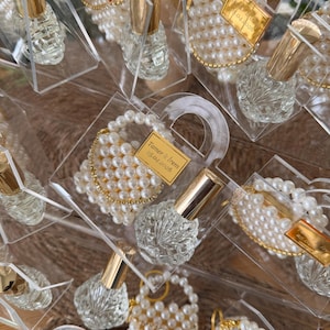 Custom gold mirrored name tag on a luxury plexi purse favor for personalized guest appreciation