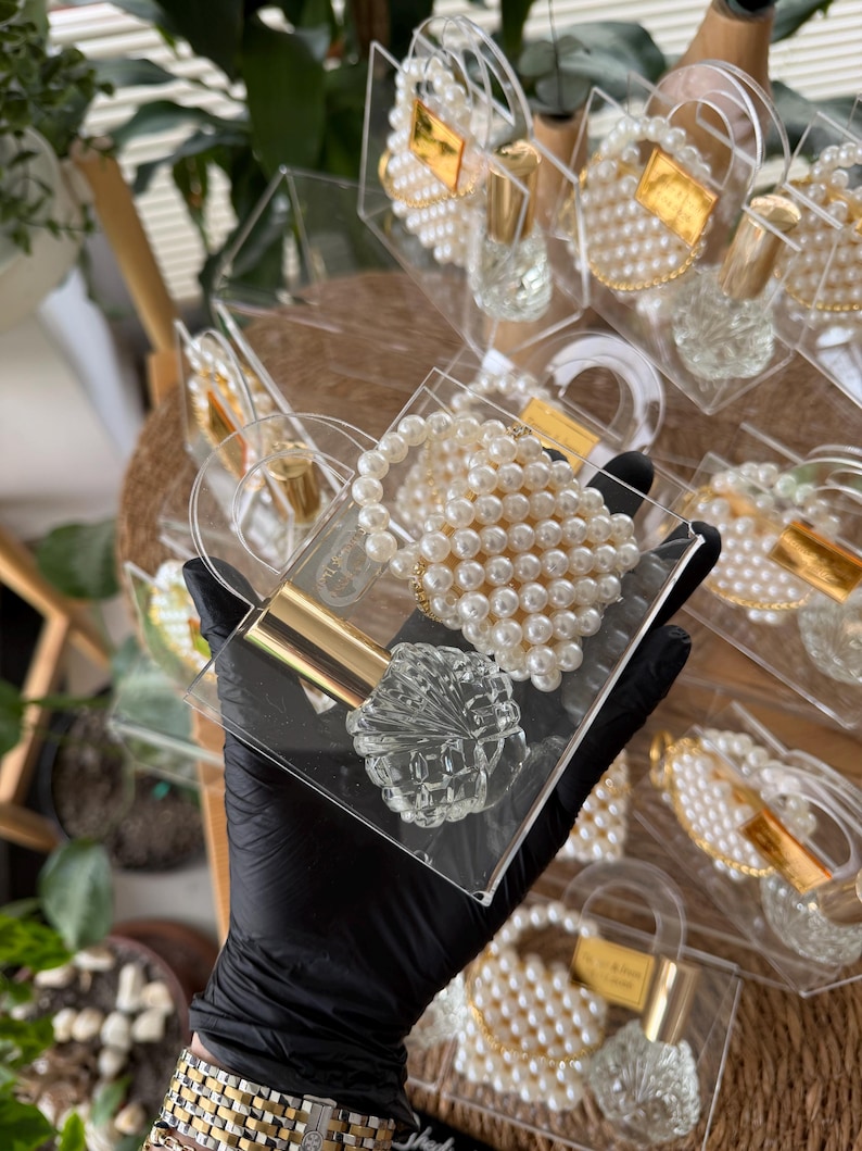Personalized clear plexi favor box with glass cologne bottle and handmade pearl keychain for wedding guests