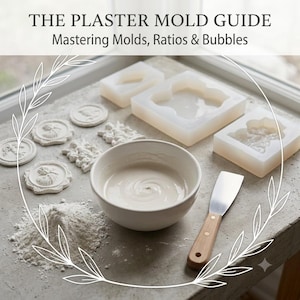 May include: A guide titled THE PLASTER MOLD GUIDE Mastering Molds, Ratios & Bubbles featuring white silicone molds, a white bowl filled with liquid plaster, a pile of white plaster powder, and a metal spatula with a wooden handle for crafting.