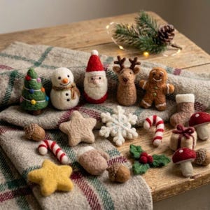 May include: A collection of small needle-felted Christmas ornaments including a green tree, white snowman, Santa Claus, reindeer, gingerbread person, star, snowflake, candy cane, stocking, mushroom, acorn, mitten, gift, and holly leaves.