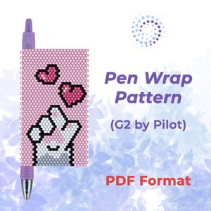 May include: A pink pen wrap pattern with a pixelated design of a hand making a heart shape, with two pink hearts above it. The text "Pen Wrap Pattern (G2 by Pilot) PDF Format" is also visible.