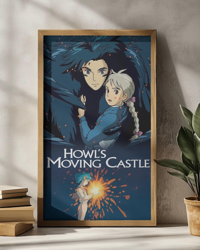 May include: A framed poster featuring artwork from the animated film "Howl's Moving Castle." The poster has a wooden frame and depicts two characters in a dark blue and orange color scheme. The film's title is displayed in white text.