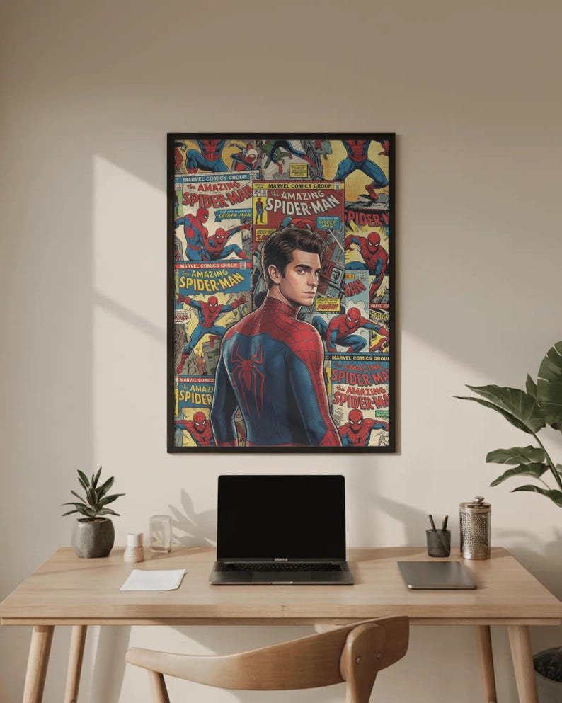 May include: A framed poster with a black border, showcasing a collage of Spider-Man comic book covers and a portrait of the superhero. The poster is displayed on a light-coloured wall. The image includes the text "AMAZING SPIDER-MAN".