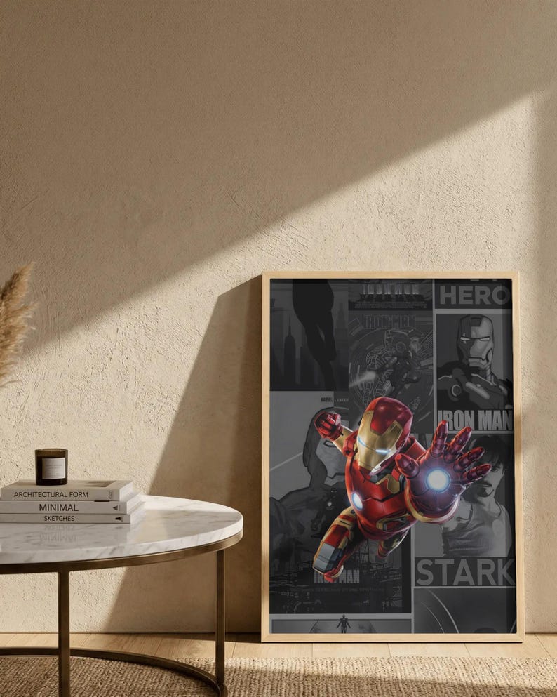 K&ouml;nnte beinhalten: Gerahmtes Poster mit Iron Man in dynamischer Pose, in einem rot-goldenen Anzug, mit leuchtender Hand. Der Hintergrund zeigt Comic-Panels in Graustufen mit den Worten "HERO", "IRON MAN" und "STARK". Das Poster h&auml;ngt an einer Wand.
