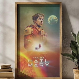 May include: A framed poster featuring a man in a red and yellow space suit, with a planet and the text "PROJECT HAIL MARY." The artwork has a sci-fi theme with a warm color palette, including orange, red, and yellow.