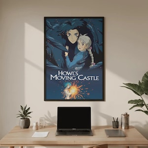May include: A framed poster featuring artwork from the animated film "Howl's Moving Castle." The poster depicts two characters in a dark, fantastical setting, with the film's title in white text. The poster is displayed on a wooden desk.