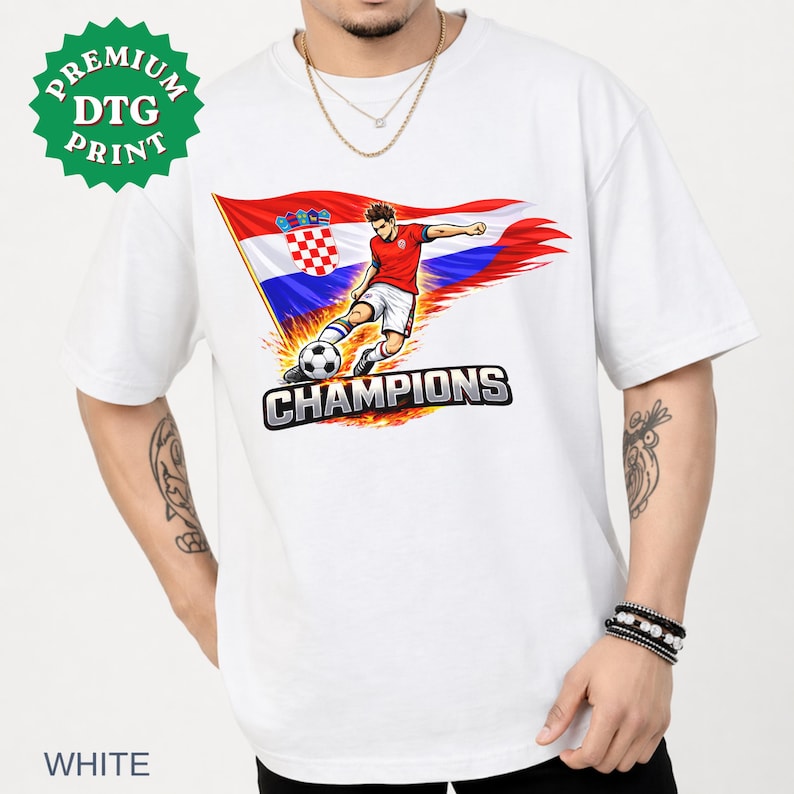 A white t-shirt with a graphic design depicting a soccer player kicking a soccer ball, with the text "CHAMPIONS" below the image.