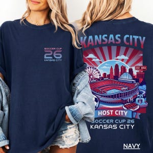 A navy back print shirt the front features a minimal "SOCCER CUP 26 KANSAS CITY" logo.