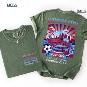 A moss back print shirt the front features a minimal "SOCCER CUP 26 KANSAS CITY" logo.